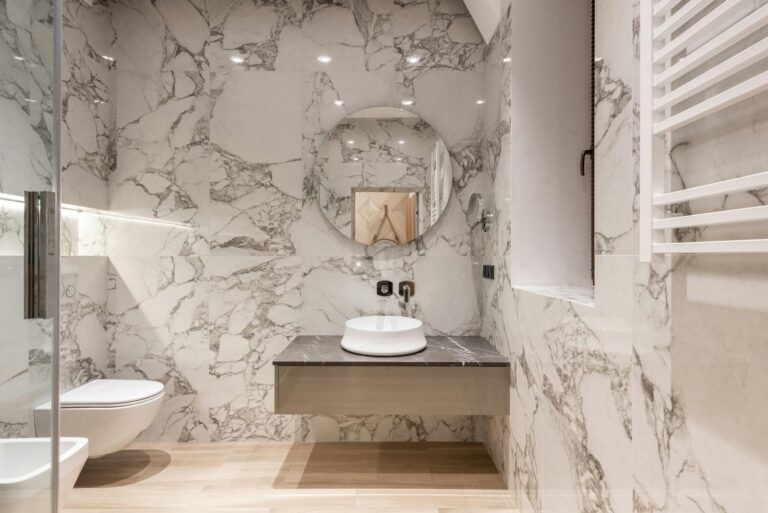 Beautiful bathroom in Dumbo with freestanding wood vanity and marble walls. Professionally cleaned by Cleanzilla