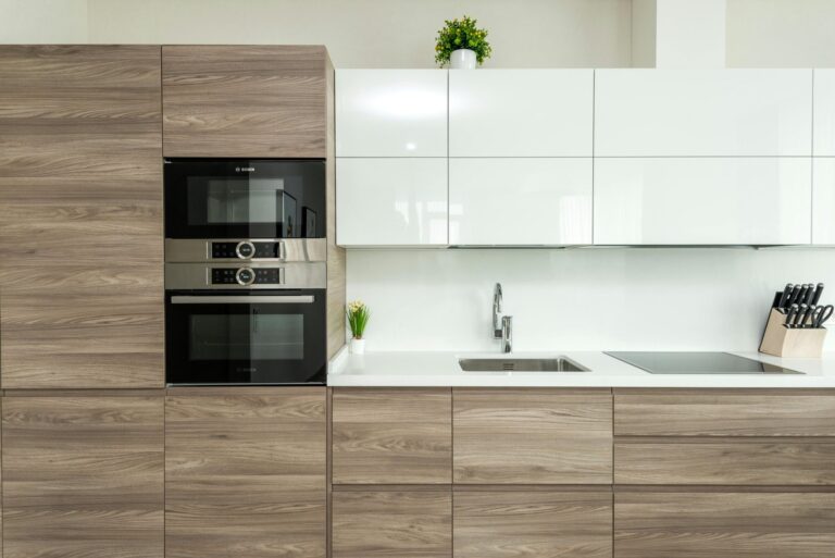 The best cleaning services in Cobble Hill, Brooklyn from Cleanzilla. Brown and white kitchen cabinets with a build in microwave. Spotless kitchen countertop