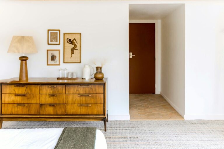 Clean NYC bedroom corridor with a brown dresser
