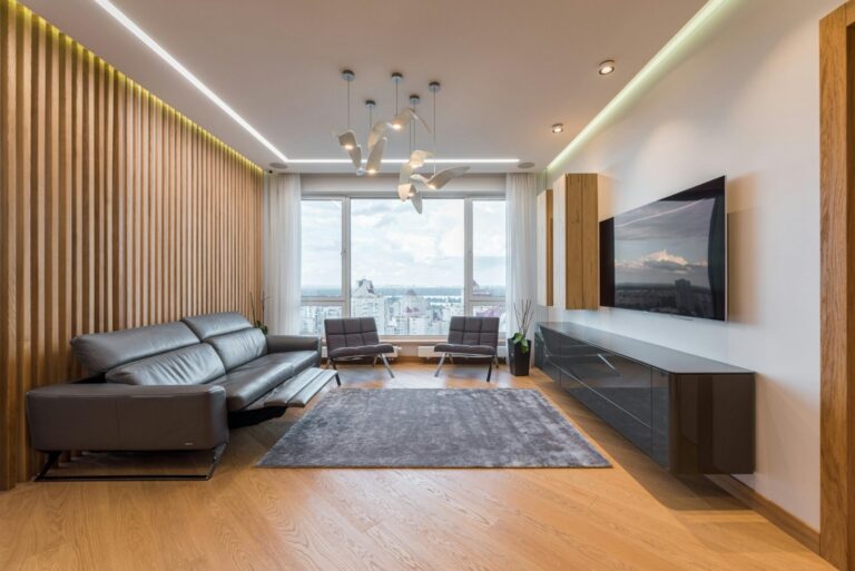 Clean apartment. orange wooden floors and dark gray living room furniture. Cleaning services in Morningside Heights